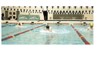 Sophomore Spencer Girard swims the breaststroke portion of the 200 medley relay. The team of Gabe Lopez