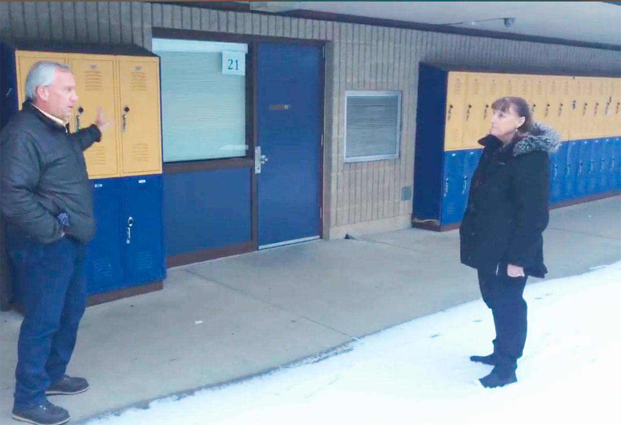 Arlington schools Superintendent Chrys Sweeting and executive director or Operations Brian Lewis tour Post Middle School to point out reasons for a bond to build a new school. For example, outdoor hallways and classroom doors only accessible from outside are a safety and security issue. Student lockers are exposed to the elements and prone to rust. Heap pumps in the rooms are noisy, and drain across walkways, creating a potential hazard on icy school days.